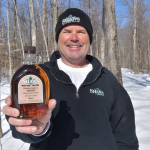 Tom showing some of the limited inventory of 2021 syrup