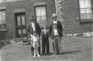 Jim Shaw with son Norman and grandchildren Ron, Pat and Doug outside the family farm house. Three generations in our history
