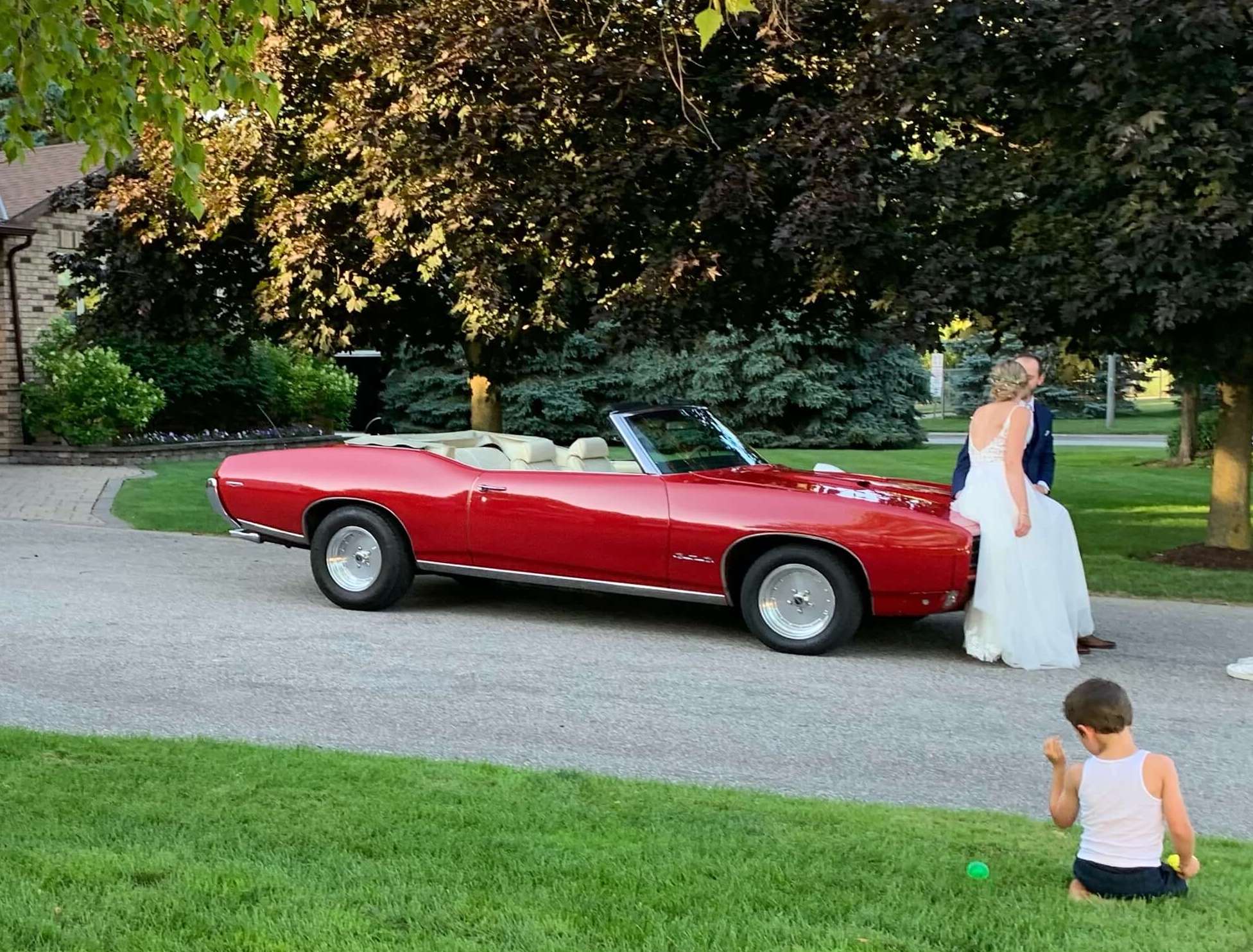 Bride and Groom pose with 1969 GTO at Holland Landing Tent Wedding