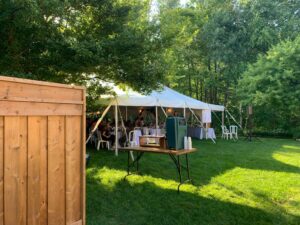 The tent in the shaded and beautifully tended yard of the groom's parents