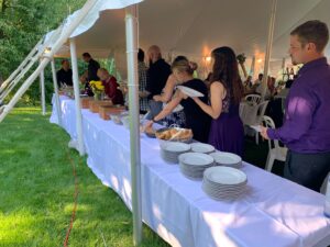 Guests enjoy the Shaws Catering buffet featuring prime rib, salmon and chicken entrees