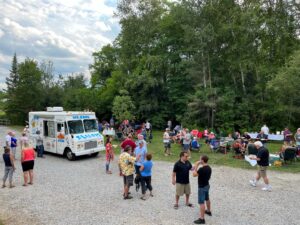 Guests mingle near the ice cream truck at a celebration of life in Sutton