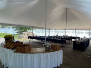 Black linens and simple flowers provide a wonderful contrast to the sand and water. Together it creates a very warm and inviting reception tent.
