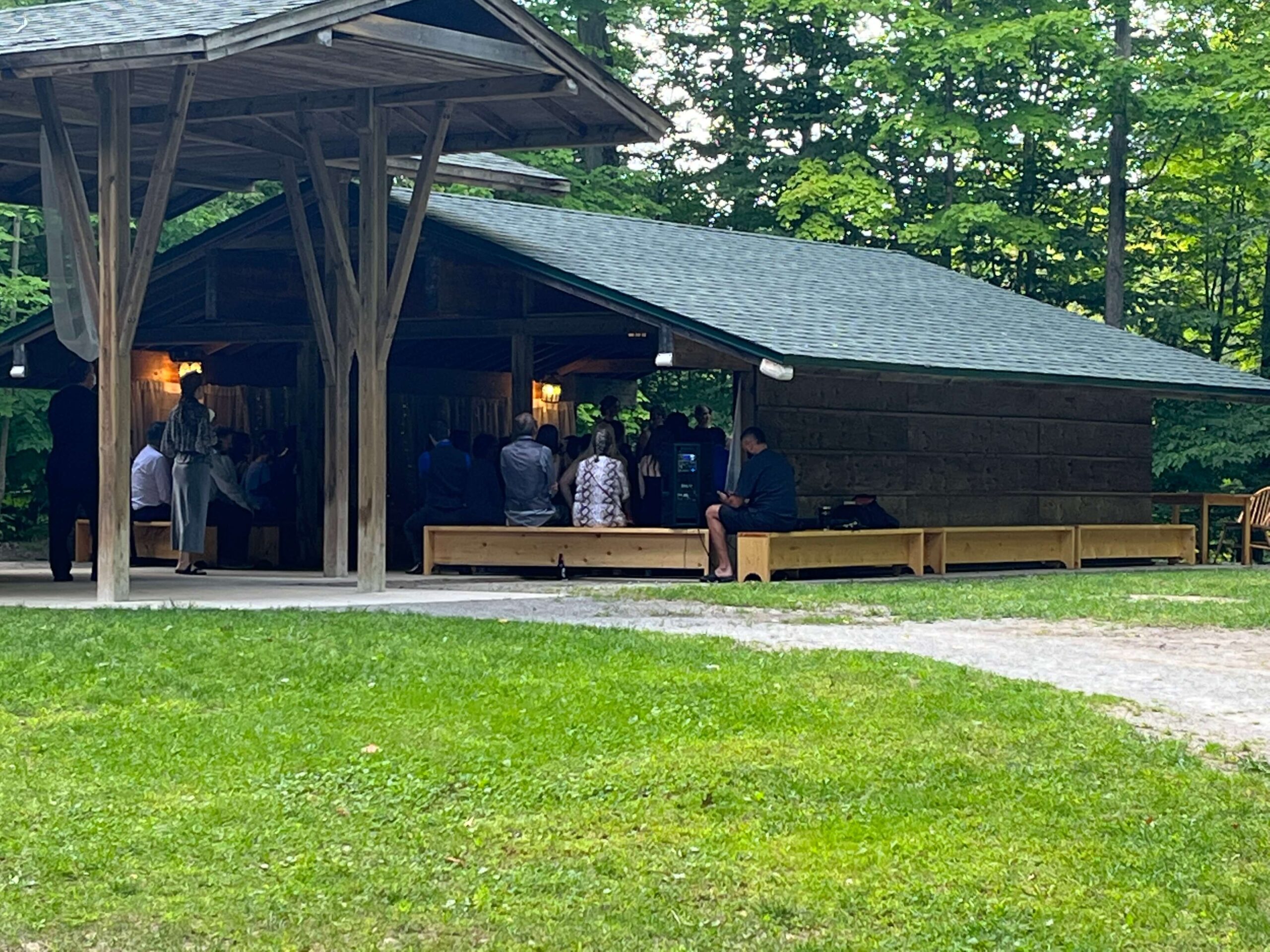 The wedding ceremony in a simple wood structure in the forest