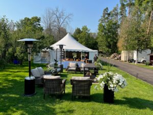 The reception tent by the fire pit on this lovely property in Hawkestone
