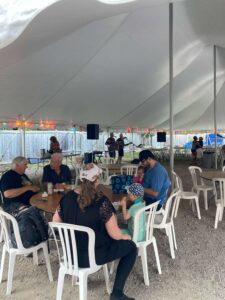 guests eat in the dining tent at the Brentwood Marine End of SEason BBQ