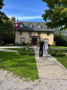 Chris and Laurie Orser pose in front of their home, built in 1852