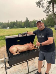 Putting the pig on the grill - Shaws DIY Pig Roast