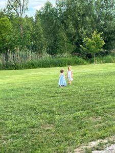 girls play out in the field at the June wedding in Alliston