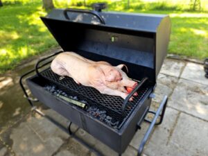 Pig on the grill with an apple in its mouth