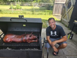 Derek, co-owner of Themagenix, poses with his Shaws DIY Pig Roast