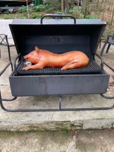 A DIY bachelor party with a Shaws DIY pig roasting on the coals