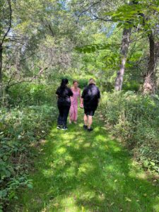 Oria guides Sherri and Becca through the lovely walking trails that cover the property