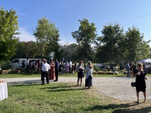 Guests mingle in the shade at this beautiful farm wedding in Vasey