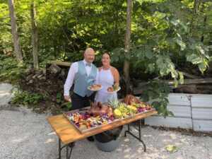 Anna & Jeff with the roast pig at their perfect backyard wedding